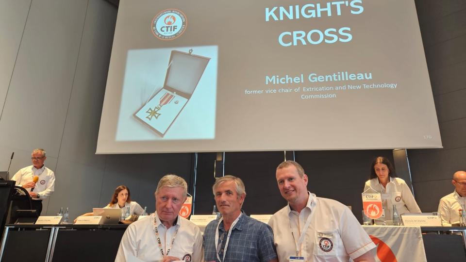 Michel Gentilleau (middle in photo) receives the Knight's Cross Award from CTIF. Left: Milan Dubravac, CTIF President. Right: Tom Van Esbroeck, CTIF Treasurer. 