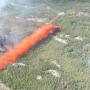 Airtanker 417 dropping 8 door string drop along the right flank of a fire. Photo: Government of the Northwest Territories.
