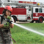 U.S. Air Force Academy Cadet 2nd Class Madison Tung sprays a fire hose during a fire training challenge at Kunsan Air Base, Republic of Korea, July 11, 2017. The visit was part of the Air Force Academy’s Operation Air Force program which allows cadets to travel different bases to learn about different careers and missions. (U.S. Air Force photo by Senior Airman Michael Hunsaker/Released)